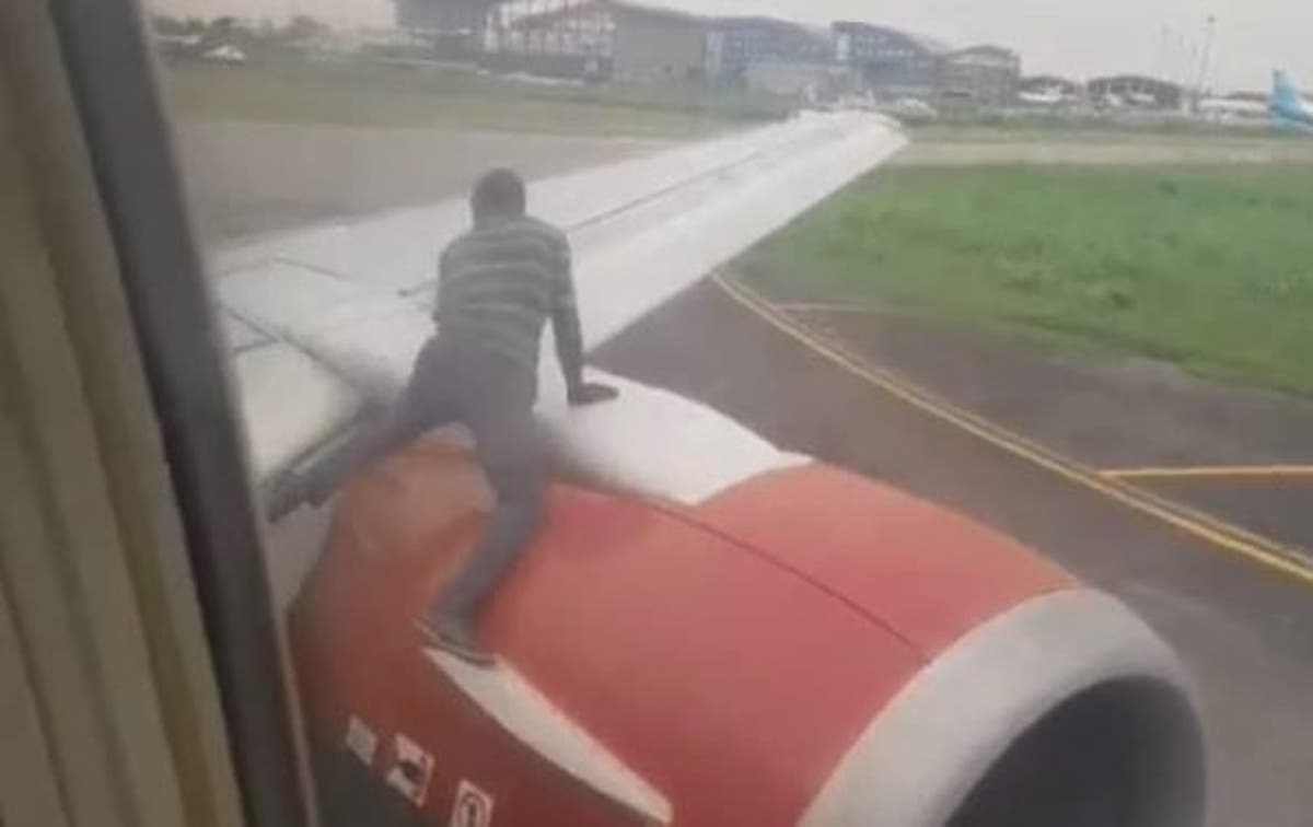 Image result for Panic as man climbs aircraft at Lagos Airport